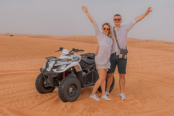 Explore the stunning desert landscape while riding a quad bike sandboarding and enjoying a camel ride. A morning of adventure awaits in the breathtaking surroundings of Dubai's golden dunes.